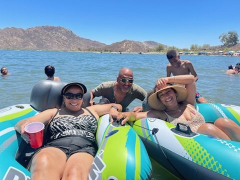Cousins floating on tubes out on the lake