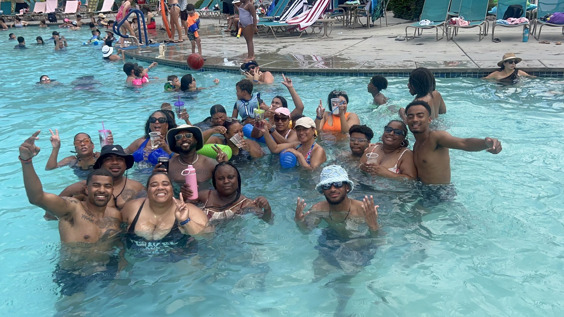 Cousins packed into the pool throwing up peace signs